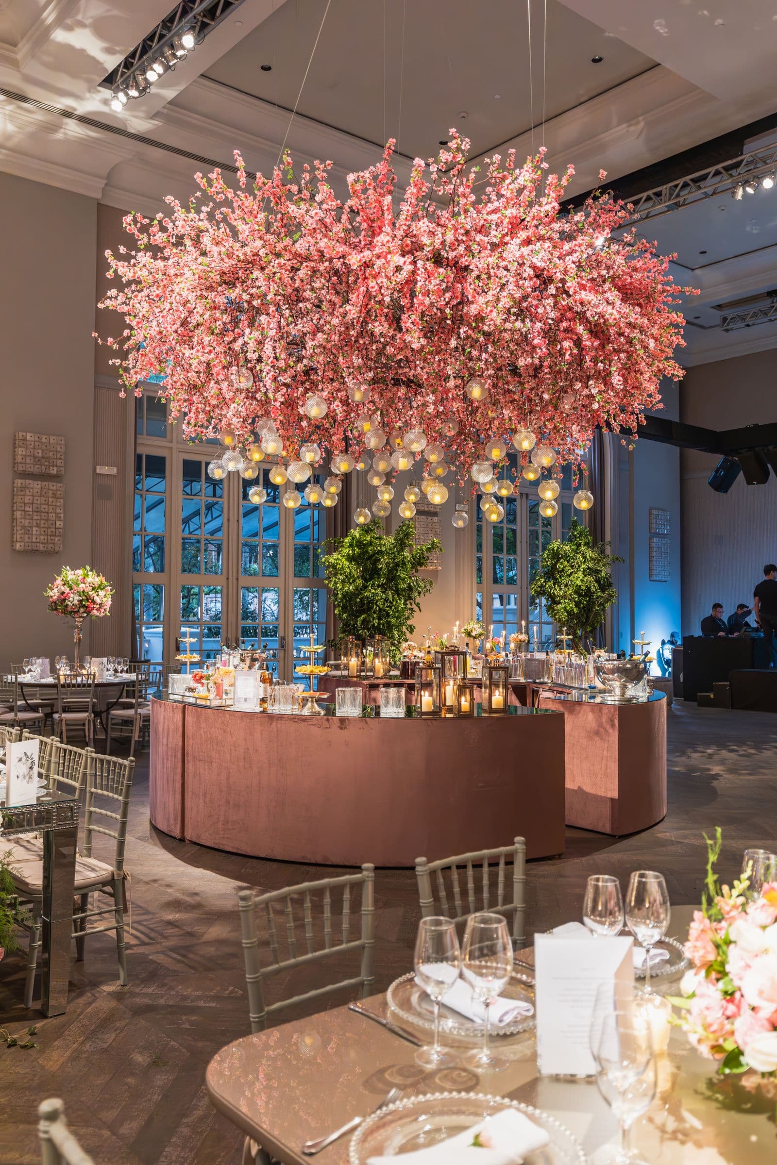 Ballroom dressed with a hanging cherry-blossom installation and glowing orbs